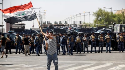 A supporter of Shiite Muslim cleric Moqtada Sadr waves an Iraqi national flag. AFP