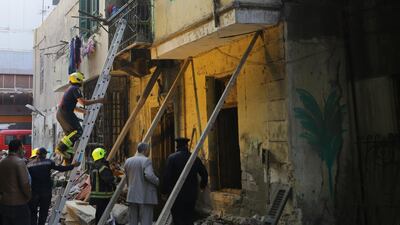 Egyptian rescue workers inspect the site of a three-storey building that collapsed in Roud Al Farag, Cairo, on Monday, February 15 2021. The authorities said at least three people died. EPA