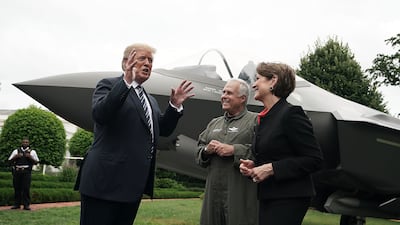 Mr Trump in conversation beside a Lockheed Martin F-35 fighter jet outside the White House in 2018. Getty Images