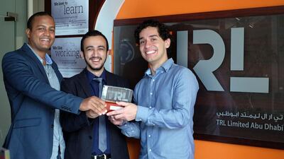 From left, Allan Pimenta, Asim Khanal and Jean Phelippe de Oliveira, master’s students at Masdar Institute of Science and Technology, after winning the TRL Student Award 2016 at Gulf Traffic. The three have designs on revolutionising Abu Dhabi’s bus system. Delores Johnson / The National