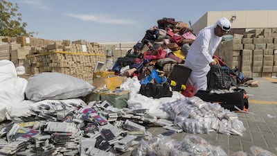 Ibrahim Behzad, director of intellectual property rights management at the Dubai Department of Economic Development, looks at a pile of counterfeit products scheduled for destruction last month. Antonie Robertson / The National