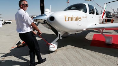 A ground crew parks an Emirates Cirrus SR22 training plane at the Dubai Airshow. Emirates Flight Training Academy took delivery of two of these planes on Thursday. Christopher Pike / The National