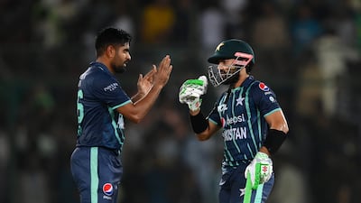 Pakistan's Mohammad Rizwan celebrates reaching fifty with Babar Azam. Getty