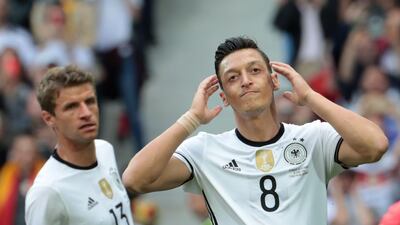 The decision by Mesut Ozil, right, to leave Die Mannschaft has unleashed a racism storm in Germany. AFP