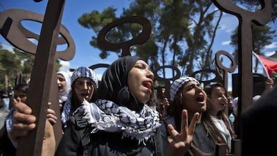 Palestinian girls hold up wooden replicas of keys, symbolising their displacement from their homes, as Palestinians mark Yawm Al Nakba in the West Bank town of Ramallah.