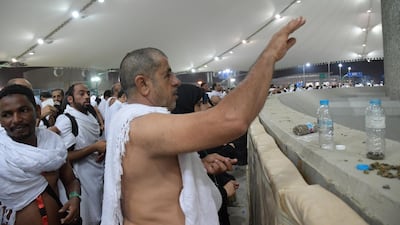 Muslim worshippers throw pebbles as part of the symbolic al-A'qabah (stoning of the devil ritual) at the Jamarat Bridge during the Hajj pilgrimage in Mina, near Makkah, Saudi Arabia. AFP