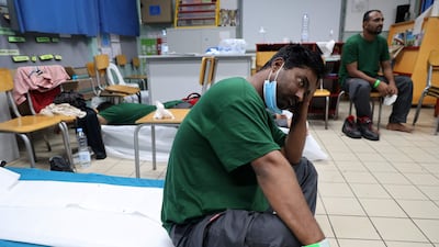Sailors rest after being rescued from a stranded oil tanker in the French Indian Ocean in February 2022. Crews face falling wages, tougher conditions and the threat of hijackings on crucial routes. AFP