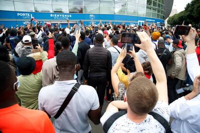 PSG fans gather outside Parc des Princes stadium on Monday ahead of the potential arrival of Lionel Messi. AFP