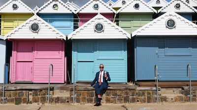 Mr Farage poses with an ice cream on the seafront, after voting in Walton-on-the-Naze. Reuters