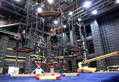 A behind-the-scenes look at acrobats in La Perle preparing to perform. Victor Besa / The National