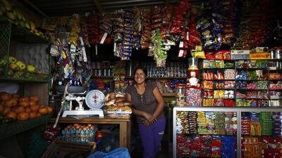 Irma Huaman poses for a photo in her grocery store in Gosen City. Huaman arrived in Gosen City 12 years ago when it was just a settlement. She initially worked as a street vendor, until she acquired a loan to build her own store. Mariana Bazo / Reuters