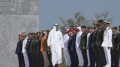 Sheikh Mohammed bin Zayed, Crown Prince of Abu Dhabi and Deputy Supreme Commander of the UAE Armed Forces, observes a moment of silence during a Commemoration Day flag raising ceremony at Wahat Al Karama, a memorial dedicated to the memory of the UAE’s national heroes in honour of their sacrifice and in recognition of their heroism. He is seen with Major General Sheikh Khaled bin Mohammed bin Zayed, Chairman of the UAE State Security Department, Sheikh Khalifa bin Tahnoun bin Mohamed Al Nahyan, Lt General Hamad Al Romaithi, Chief of Staff UAE Armed Forces, Major General Essa Saif Al Mazrouei, Deputy Chief of Staff of the UAE Armed Forces, Mohammed Mubarak Al Mazrouei, Undersecretary of the Crown Prince Court of Abu Dhabi, and others. Philip Cheung / The Crown Prince Court - Abu Dhabi
