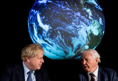 British Prime Minister Boris Johnson and conservationist David Attenborough speak with school children during a conference about the Cop26 UN Climate Summit. Reuters