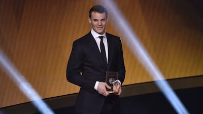 Bayern Munich and Germany goalkeeper Manuel Neuer poses with his trophy after being selected as goalkeeper for the 2014 Fifa FIFPro World XI on Monday night at the Ballon d'Or awards ceremony. Fabrice Coffrini / AFP / January 12, 2015