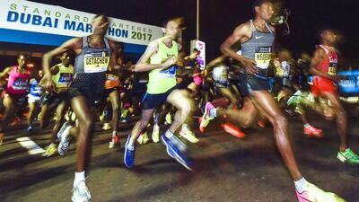 The Dubai Marathon course is perhaps unique in allowing participants to race alongside elite runners. AFP