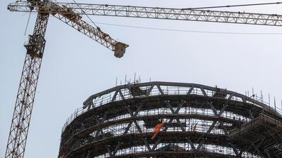 Cranes tower over a building at Emaar's Dubai Hills development. Antonie Robertson / The National