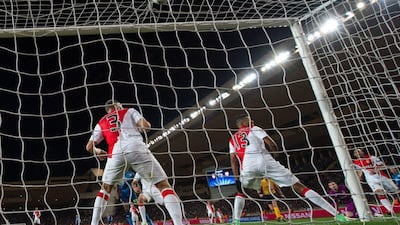 Monaco defender Wallace, right, watches as the ball goes into his side's net for a goal by Arsenal's Olivier Giroud, unseen, to make it 1-0 for the visitors at the Stade Louis II on Tuesday. Bertrand Langlois / AFP