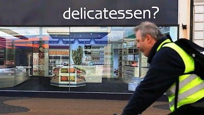 A man cycles past a fake shop front in Whitley Bay. AFP