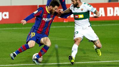 Lionel Messi takes on Elche defender Miguel Angel Garrido Cifuentes. EPA