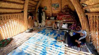 An Iraqi man sits in his house which is made of reeds at the Chebayesh marsh in Dhi Qar province. Reuters