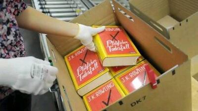 A worker packs the new J K Rowling's novel 'A Sudden Death' in Stuttgart, Germany. The new book will be release on Thursday 27 September. EPA/Franziska Kraufmann