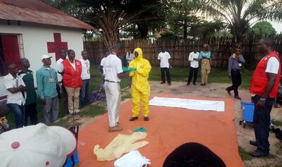 A Red Cross team dons protective clothing before heading out to look for possible cases of Ebola in Mbandaka, a city in the Democratic Repuplic of Congo's Equateur province. Karsten Voigt / International Federation of Red Cross and Red Crescent Societies via AP