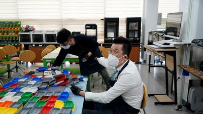 A professor talks with his colleagues as he works at Pusan National University in Busan, South Korea. Reuters