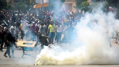 Ansar Al Shariah supporters clash with Tunisian police officers after Tunisia's Interior Ministry banned their annual conference in Kairouan, in Ettadhamen, near Tunis.