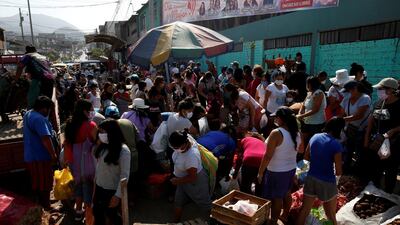 Women shop at a market after the Peruvian government limited men and women to alternate days for leaving their homes, in an attempt to slow the spread of coronavirus, in Lima, Peru. Reuters
