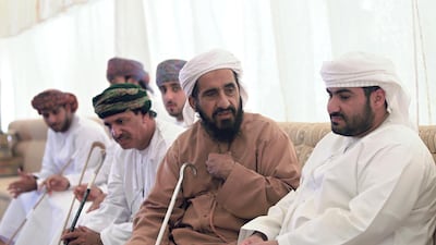 The dead soldier’s father Khalid Khalifa Al Risi, right, and next to him the teenager’s grandfather Khalifa Abdullah Salim Al Risi, receive condolences from friends and relatives in a special mourning tent at their home in Al Yahar in Al Ain. Ravindranath K / The National