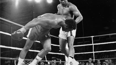 Muhammad Ali kncoks down George Foreman during the Rumble in the Jungle in Zaire in 1974. AP