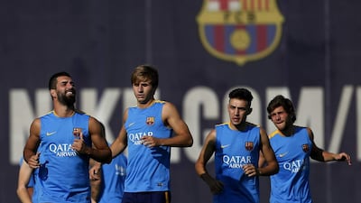 New Barcelona player Arda Turan, left, takes part in training. Josep Lago / AFP / July 13, 2015