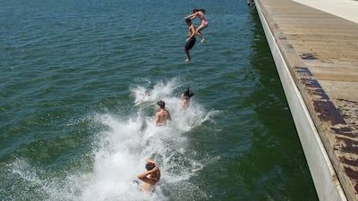 Youths leap from St Kilda Pier in Melbourne, Australia, as Victoria state swelters in a heatwave. EPA