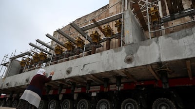 A woman reacts as Er Rizk Mosque from the 15th century is transported from the ancient town of Hasankeyf by the Tigris river, which will be significantly submerged by the Ilisu dam. Reuters