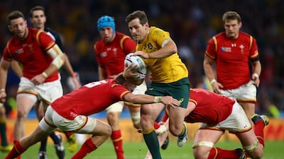 Australia’s Bernard Foley, centre, tries to break free against a rampaging Wales defence in their Pool A match at the Twickenham Stadium last night. Steve Haag / Gallo Images