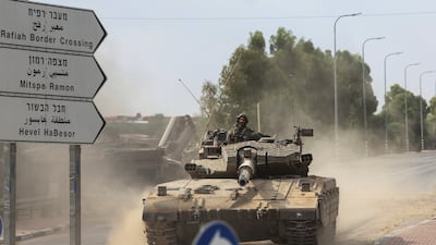 Israeli soldiers drive a tank near the country's border with Gaza on Tuesday. Reuters