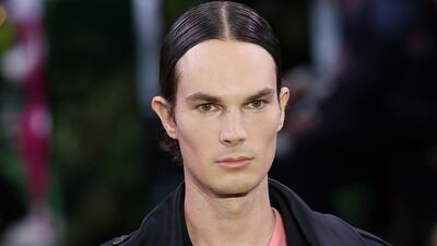 A model clutches a vase during the Versace spring/summer 2023 menswear show at Milan Fashion Week. Getty Images