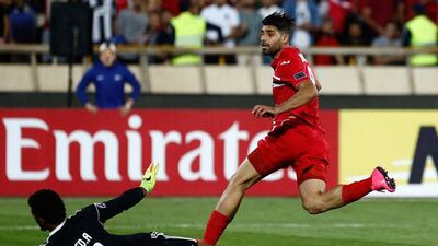 Mehdi Taremi scored three of Perspolis's four goals to eliminate Al Wahda from the Asian Champions League. Abedin Taherkenareh / AFP