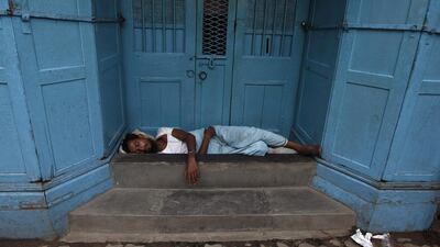 A man sleeps on the doorway of a closed shop at a market in Kolkata. Rupak De Chowdhuri / Reuters