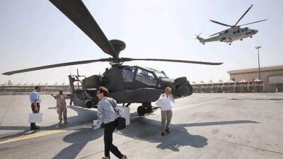 People try to keep the wind caused the takeoff of a helicopter of the search and rescue team of Abu Dhabi aviation at Dubai Helicopter Exhibition at Airport Expo Centre. Jaime Puebla / The National