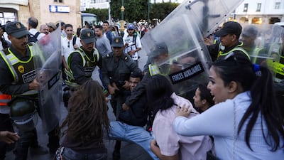 Members of the security forces detain a protester. AFP