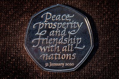 The inscription on the 50 pence coin that has been specially minted for the occasion says: 'Peace, prosperity and friendship with all nations.' EPA