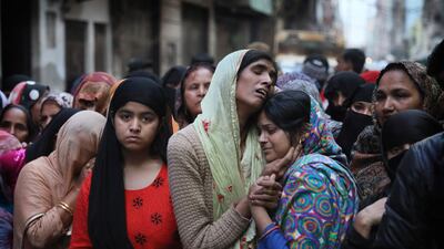 Relatives and neighbours wail near the body of a loved one who was killed in communal violence in New Delhi last week. AP Photo