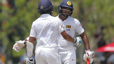 Sri Lankan batsman, Kusal Mendis, left, is congratulated by team mate Kusal Janith Perera, after scoring a half-century during the first day of their second cricket test match against Australia in Galle, Sri Lanka, Thursday, Aug. 4, 2016. (AP Photo/Eranga Jayawardena)