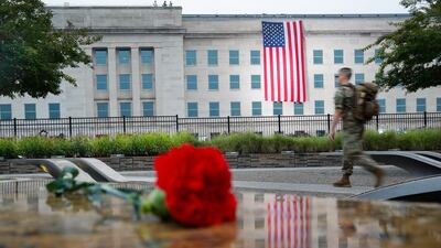 A member of the military walks the grounds of the National 9/11 Pentagon Memorial. AP Photo