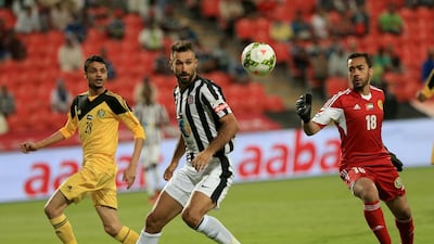 Mirko Vucinic, centre, Kalba’s goalkeeper Saif Rashed, right, and Fahad Feraish in action. Ravindranath K / The National