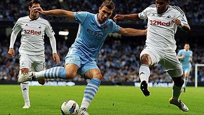 Edin Dzeko, centre, opened the scoring for Manchester City in their 4-0 win against Swansea City.
