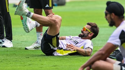 Virat Kohli stretches during practice. AFP