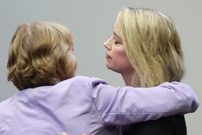 Amber Heard is comforted by lawyer Elaine Bredehoft after the verdict last month. AP