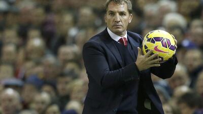 Liverpool manager Brendan Rodgers catches the ball during the English Premier League match against Arsenal at Anfield in Liverpool, northern England, on December 21, 2014. Phil Noble / Reuters